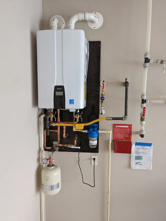 Professional plumber installing copper piping in a Highland Acres home